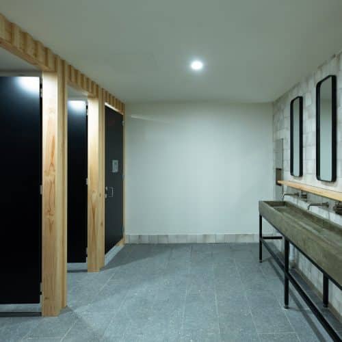 Durable compact laminate toilet partitions in a high-traffic environment.